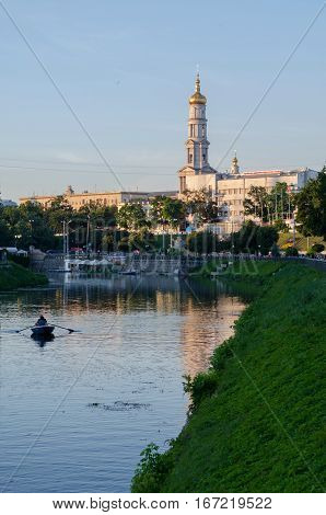 KHARKIV UKRAINE - JULY 06 2016: The bell tower of the Assumption Cathedral (Uspenskiy Sobor) philharmonic organ hall in Kharkiv Ukraine view from the river