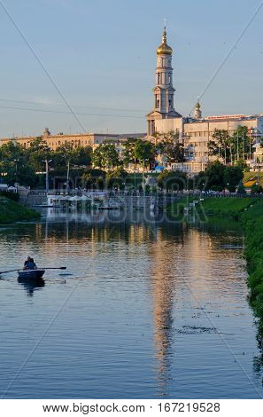 KHARKIV UKRAINE - JULY 06 2016: The bell tower of the Assumption Cathedral (Uspenskiy Sobor) philharmonic organ hall in Kharkiv Ukraine view from the river