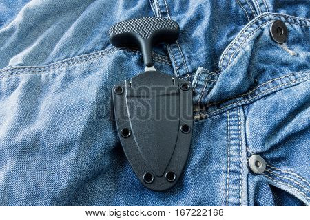 Urban Knife In Case On Jeans Background. The Vertical Position.