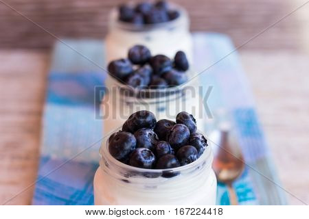Homemade yogurt with blueberries in a glass jar