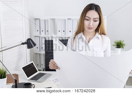 Young Architect Examining Project