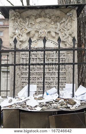 KRAKOW POLAND - MARCH 20 2116 : Tombstone (matzeva) of Moses on Remuh Cemetery with lot of kvitlech. Old Jewish Cemetery of Krakow is an inactive Jewish historic cemetery established in 1535.It is located next to the 16th-century Remah Synagogue.