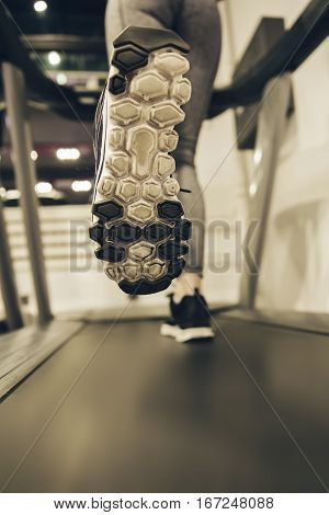 Woman's Feet While Walking On Threadmill At Gym
