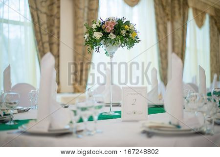 The table decorations for weddings with tall flower arrangement. Wedding concept