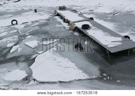 Frozen River With Accumulated Drift Ice Putting Preasure On Docks And Boats