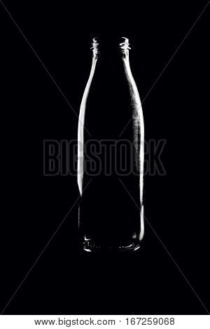 Empty glass bottle isolated on black background