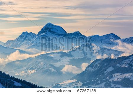 Beautiful winter landscape in the Mont Blanc Massif with the view to the Chaine des Aravis above the clouds and villages.