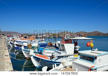 ELOUNDA, CRETE - SEPTEMBER 17, 2016 - The fronts of a row of traditional fishing boats in the harbour Elounda Crete Greece Europe, September 17, 2016.