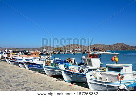 ELOUNDA, CRETE - SEPTEMBER 17, 2016 - The fronts of a row of traditional fishing boats in the harbour Elounda Crete Greece Europe, September 17, 2016.