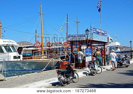 ELOUNDA, CRETE - SEPTEMBER 17, 2016 - Spinalonga trip booking office with boats moored in the harbour Elounda Crete Greece Europe, September 17, 2016.