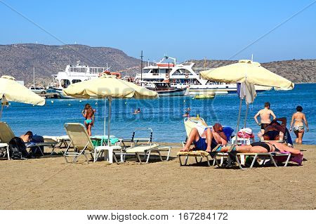 ELOUNDA, CRETE - SEPTEMBER 17, 2016 - Tourists relaxing on the beach Elounda Crete Greece Europe, September 17, 2016.