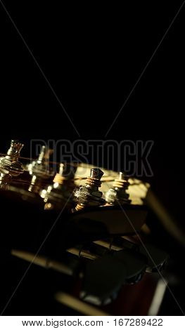 Closeup Of Acoustic Guitar Over Black Backgraound Shallow Depth Of Field