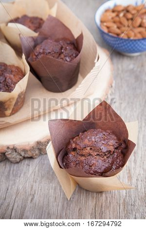 Flourless chocolate courgette muffins on a wooden table