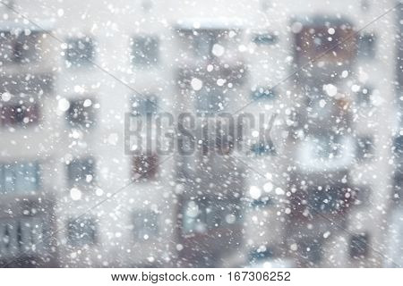 Abstract photo of the snowstorm and residential building on a background
