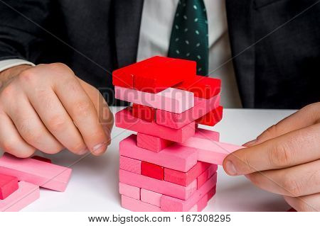 Businessman Builds Big Tower With Jenga Bricks