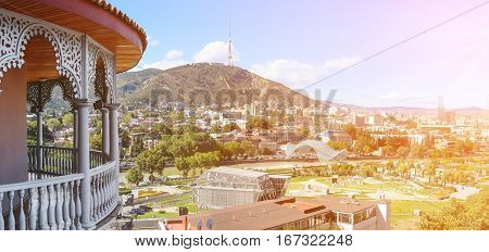 Panoramic view of Tbilisi Georgia with Bridge of Peace and Rike Park from the carved balcony
