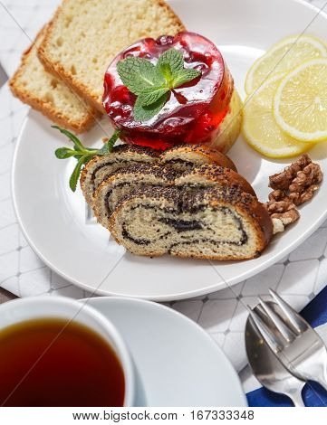 Delicious dessert consisting of cake roll with poppyseed and lemon