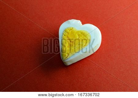 Egg heart on red background. Romantic background concept