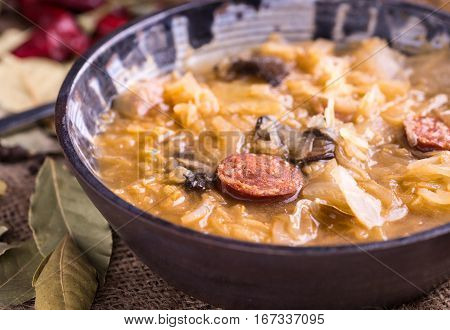 Christmas cabbage soup with mushrooms on natural background.