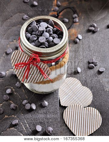 Cookie mix with chocolate chips in glass jar. St. Valentine's day gift concept selective focus toned image