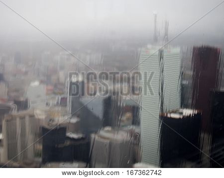 A gloomy fiew of downtown Toronto Canada through a glass window on a rainy day.