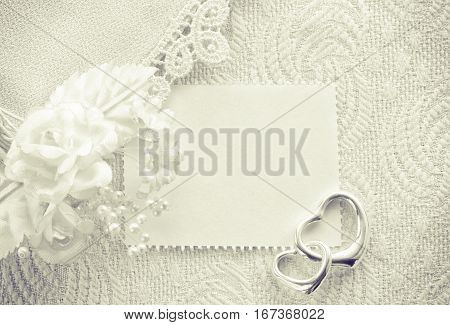 wedding invitation valentine day concept monochrome card with a clothes detail lace boutonniere two silver heart pendant