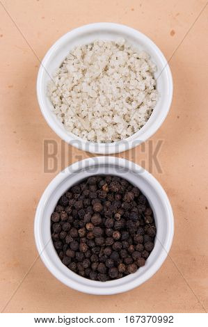 Course Gray Salt And Peppercorns In Smal Ramekins On Saltillo Tile