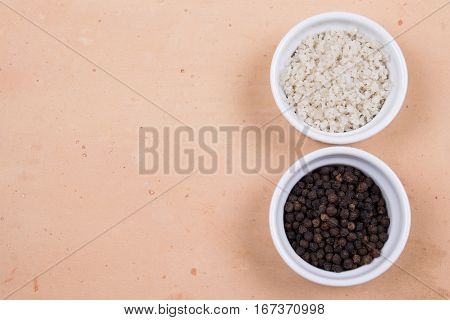 Course Gray Salt And Peppercorns In Smal Ramekins On Saltillo Tile