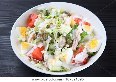 studio shot of fresh caeser salad with dressing