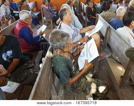 CHIANG RAI THAILAND - DECEMBER 19 : Unidentified asian old people suffering from leprosy reading and waiting for treatment on December 19 2016 in Chiang rai Thailand.