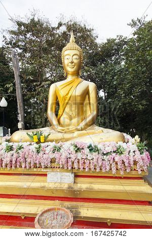 Big Gold Buddha sits and silently watches vanity below