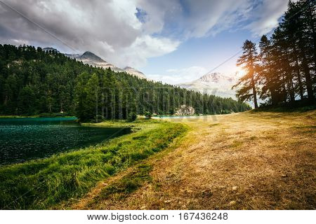 Great view of the azure pond Champfer in alpine valley. Picturesque and gorgeous scene. Location Swiss alps, Silvaplana village. Europe. Retro and vintage style. Instagram toning effect. Beauty world.