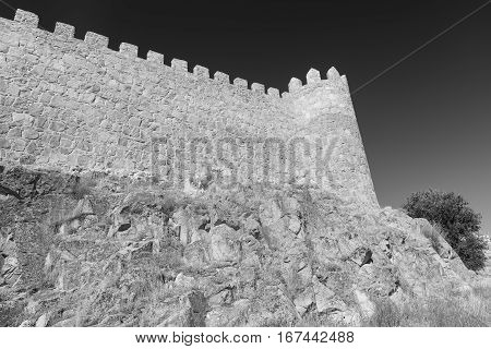 Avila (Castilla y Leon Spain): the famous medieval walls surrounding the city. Black and white