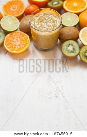Smothie rich in vitamin C made with oranges, lemons, limes, clementines, kiwis copy space for text, selective focus