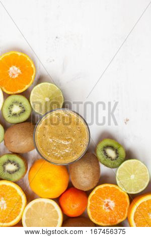 Smothie rich in vitamin C made with oranges lemons limes clementines kiwis; top view; selective focus
