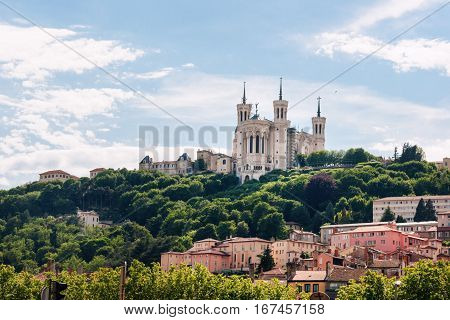 Colorful houses of Lyon and Fourviere Basilica from the Saone riverbank, France.