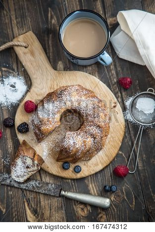 Cake. Marble cake cup of coffee powder sugar kitchen vintage utensil and fresh fruit berries.