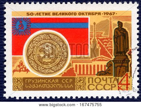 USSR - CIRCA 1967: post stamp printed in the USSR shows Coat of Arms, Flag and monument Georgian Soviet Socialist Republic, serie 