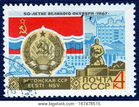 USSR - CIRCA 1967: post stamp printed in the USSR shows Coat of Arms, Flag and monument  Estonian SSR, serie 