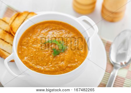 Delicious cream soup made of lentil on table top view close-up