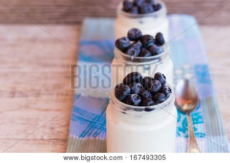 Homemade yogurt with blueberries in a glass jar
