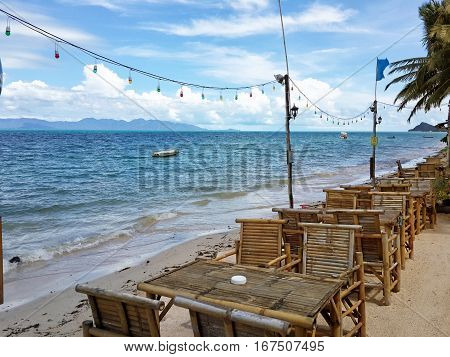 Bamboo cafe tables on sandy sea coast. Island Koh Samui Thailand