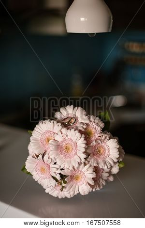 Pink gerbera daisies in the bouquet the wedding rings on the flowers