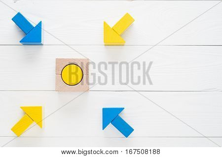 Four wooden arrows converge towards the center target with copy space top view flat lay. Arrows pointing to the object. The concept of the goal the implementation of the planned success business.