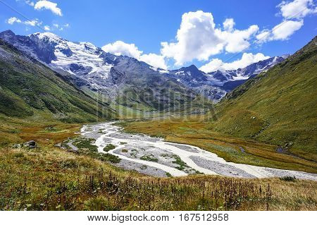 View of the valley in the mountains glacier and flooded river