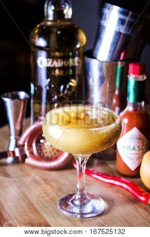 SAINT-PETERSBURG RUSSIA - January 2017: Alcohol yellow coctail drink with mexican tequila hot tabasco on restaurant background. Editorial use only.