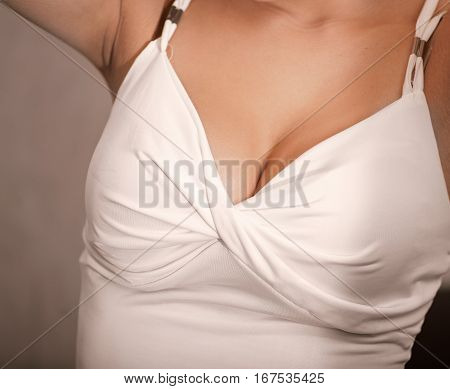 Fetish decolette of young girl. Sensuality concept. Closeup of big breasts in white lingerie.