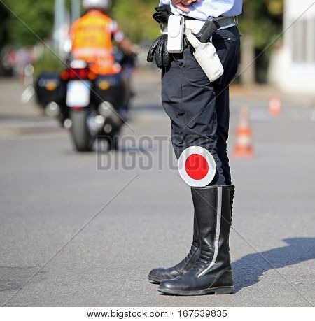Traffic Pallet In The Black Boots Of A Traffic Warden In The Cit