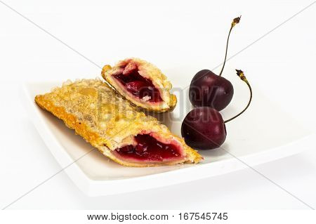 Puff pastry with fresh cherries on a white background