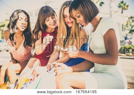 Multiethnic group of girls shopping - Four beautiful woman having fun while buying some presents in a mall in Beverly Hills